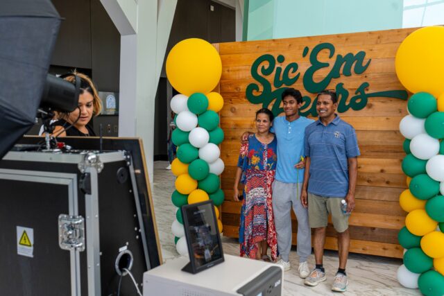 Rohanna Dodla, Srini Bondakadi and their son Joseph get picture taken at A Waco Welcome event.