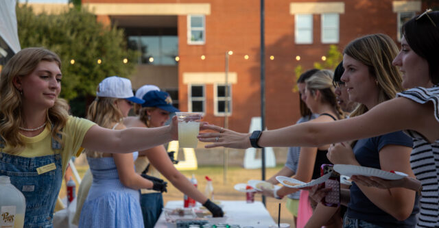 Tri Delta sisters pouring out drinks on Thursday evening at their pancake philanthropy event to help raise money for St. Jude's Hospital. Lily LeMaire | Photo Intern