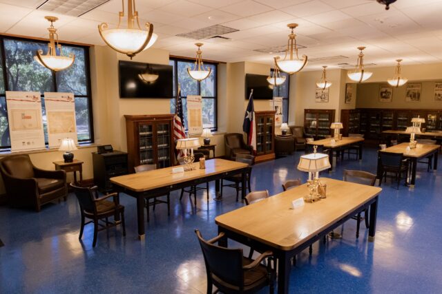 The quiet reading room of the Texas Collection at Baylor University, located inside Carroll Library, featuring spacious wooden tables and warm lighting. Walter Guerrero | Photographer