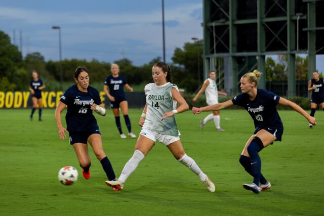#14 F Theresa McCullough battles through a pair of Marquette defenders during a home match at Betty Lou Mays Field Thursday afternoon. Walter Guerrero | Photographer