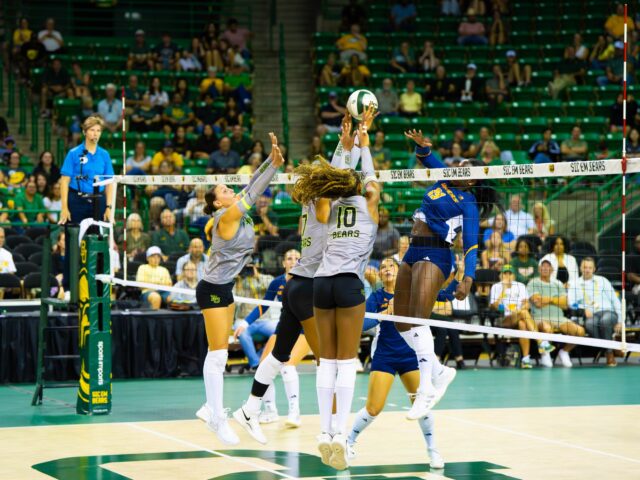 Freshman outside hitter Nadiya Johnson blocks the ball. Layla Bazan | Photographer