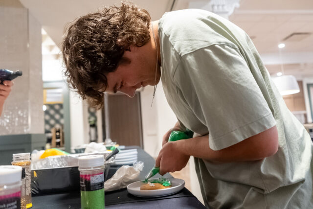 Boerne freshman Josh Patteson focuses hard on his self portrait cookie during the grand opening of Memorial Dining Hall at 2 p.m. on Thursday. Vanessa Adams | Photographer