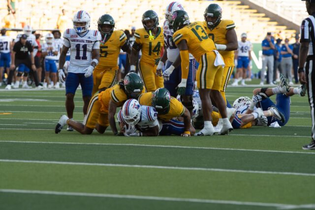 Players pile onto opponents from Louisiana Tech during the game at McLane Stadium on Saturday at 3 p.m. Vanessa Adams | Photographer
