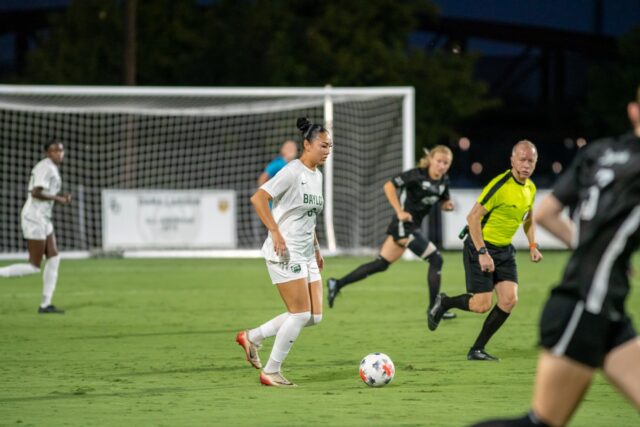 Port Coquitlam, British Columbia, Canada junior midfielder Noelle Sather dribbles the ball while surrounded by opponents during Baylor's 2-1 game against Oklahoma State as Betty Lou Mays field Thursday night. Vanessa Adams