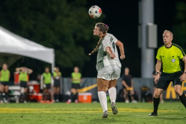 Senior forward Callie Conrad heads the ball to take control. Vanessa Adams | Photographer