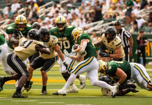 Senior running back Dawson Pendergrass runs the ball during the Baylor vs. Colorado game at McLane Stadium on Saturday. Mim Robbins | Photographer.