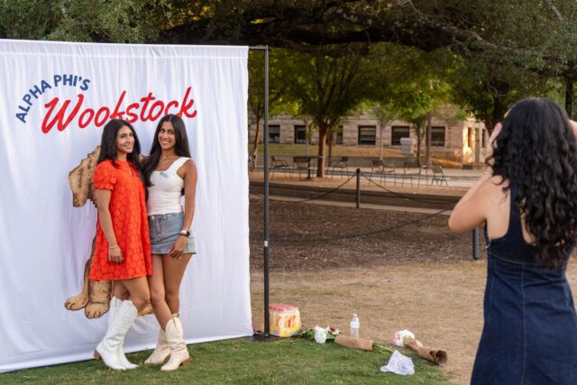 Students take photos at the Alpha Phi Woofstocks event on Fountain Mall friday night. Mesha Mittanasala | Photographer