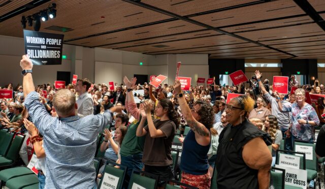 Attendees hold up campaign signs as Talarico approaches the stage at his rally at the Hurd Welcome Center on Wednesday night. Mesha Mittanasala | Photographer
