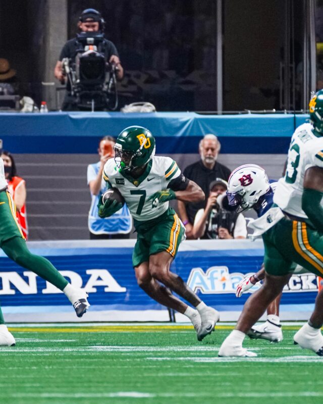 Junior cornerback Devon Jordan works his away around Auburn players after intercepting Byrum Brown. Photo courtesy of Baylor Athletics