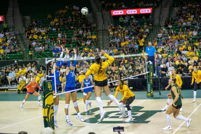 Sophomore outside hitter Ksenia Rakhmanchik jumps to spike the ball against the Florida Gators at Ferrell Center Saturday afternoon. Caleb Garcia | Photo Editor