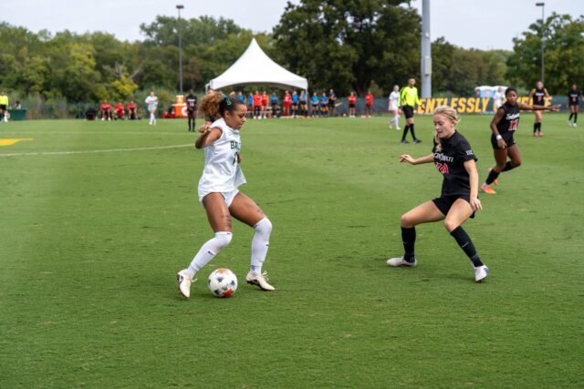 Senior Midfielder Aryanna Jimison tries to weave a defender at the Cincinnati vs Baylor soccer game at the Betty Lou Mays Field on Sunday afternoon . Caleb Garcia | Photographer