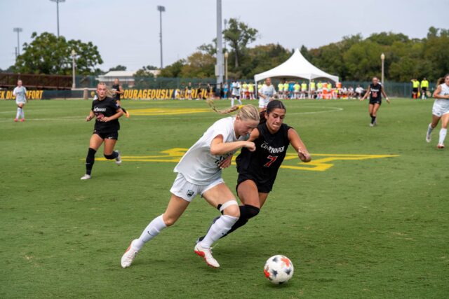 Freshman forward Grace White competes for the ball with a defender at the Cincinnati vs Baylor soccer game at the Betty Lou Mays Field on Sunday afternoon . Caleb Garcia | Photo Editor