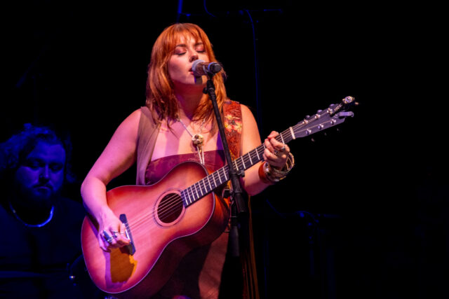 Cassidy Daniels sings her slow heartfelt song "Heart Shaped Necklace" as the opener for Braxton Keith at Foster Pavilion on Friday night. Caleb Garcia | Photo Editor
