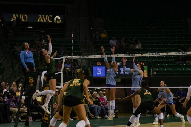 Defending the Baylor territory, sophomore outside hitter Ksenia Rakhmanchik soars to the net to deliver a lethal blow against the Jayhawks. Mady Mijares | Photographer
