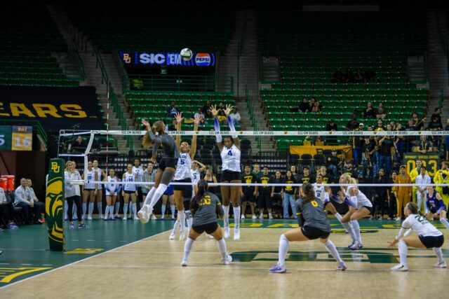 Senior middle blocker Victoria Davis leaps to strike the ball during Baylor’s match against TCU at the Ferrell Center. Layla Bazan | Photographer