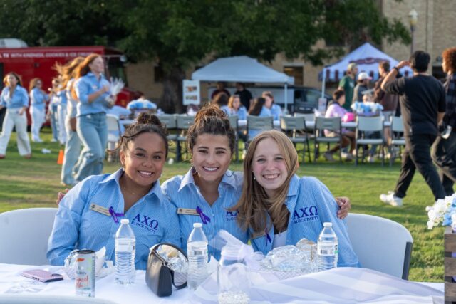 San Antonio sophomore Olivia Lopez, Waco sophomore Daniela Scata and San Antonio senior Kenzie Hoffpauir pose while eating dinner at the block party. Vanessa Adams | Photographer
