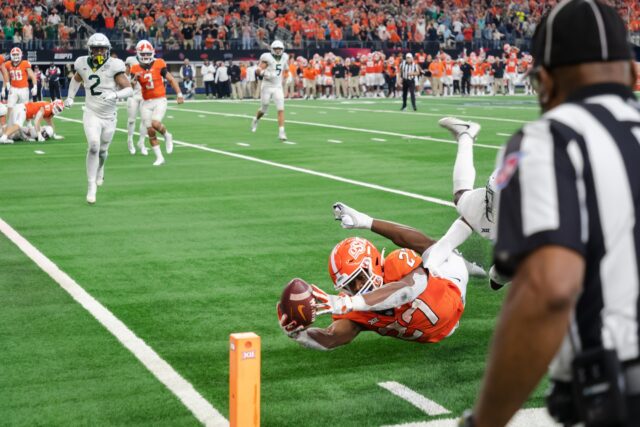 Redshirt senior running back Desmond Jackson reaches for the pylon while being tackled by senior safety Jairon McVea in the 2021 Big 12 Championship at AT&T Stadium in Arlington. Lariat file photo