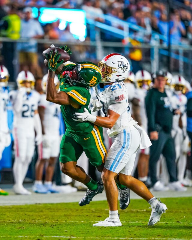 Junior wide receiver Dre'lon Miller lunged to make a tightly-contested catch against defensive back Ty Bartrum. Photo courtesy of Baylor Athletics